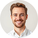 Head-and-shoulders portrait of a smiling man in a white shirt for a professional headshot